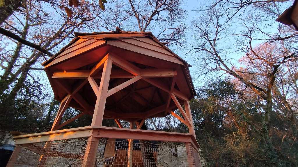 Pavillon zome en bois sur une structure surélevée